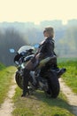 Portrait of a beautiful blonde woman on a sports motorcycle Royalty Free Stock Photo