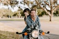 Portrait of Attractive Good Looking Young Modern Trendy Fashionable Guy Girl Couple Riding on Green Motorcycle Cruiser Old School Royalty Free Stock Photo