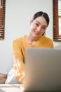 Attractive Asian woman using laptop computer in her living room, working from home Royalty Free Stock Photo