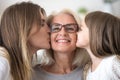 Portrait of granddaughter and daughter kissing grandmother Royalty Free Stock Photo