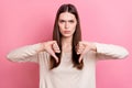 Portrait of attractive grumpy brown haired girl showing thumb down no against isolated over pink pastel color background Royalty Free Stock Photo