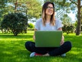 Portrait of attractive happy woman with laptop outdoors. Online education Royalty Free Stock Photo