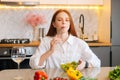 Portrait of attractive happy young redhead woman eating fresh vegetarian salad enjoying fresh tasty vegetables with Royalty Free Stock Photo