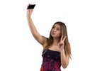 Portrait of attractive and hot girl in short tight dresses making selfie on smartphone camera, isolated white background Royalty Free Stock Photo