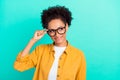 Portrait of attractive intellectual curious girl touching specs thinking isolated over bright teal turquoise color