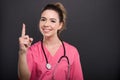 Portrait of attractive lady doctor showing number one gesture Royalty Free Stock Photo