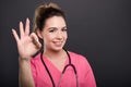 Portrait of attractive lady doctor showing ok gesture Royalty Free Stock Photo