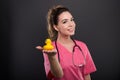 Portrait of attractive lady doctor showing bath duck