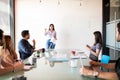 Woman giving presentation to her colleagues at office Royalty Free Stock Photo