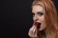 Portrait of attractive  long hair young woman tasting strawberry Royalty Free Stock Photo