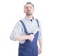 Portrait of attractive male mechanic in blue overalls holding wrench Royalty Free Stock Photo