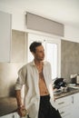 Attractive male slob drinking whiskey in his kitchen Royalty Free Stock Photo