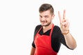 Portrait of attractive male supermarket employer showing peace g