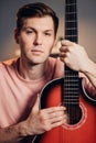 Portrait of attractive man with guitar looking at camera Royalty Free Stock Photo