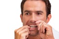 Portrait of attractive man looking in the mirror while flossing hsi teeth Royalty Free Stock Photo