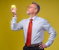 Portrait of attractive man posing on camera. Holding yellow apple in hand. Isolated over white background. Royalty Free Stock Photo