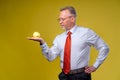 Portrait of attractive man posing on camera. Holding yellow apple in hand. Isolated over white background. Royalty Free Stock Photo