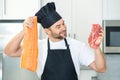 Portrait of attractive man preparing fresh natural meal at kitchen home indoors. Handsome cheerful man preparing raw Royalty Free Stock Photo