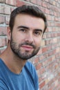 Portrait of attractive man on red brick wall background / Closeup of young interesting natural male Royalty Free Stock Photo