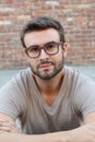 Portrait of attractive man on red brick wall background / Closeup of young interesting natural male