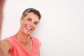 Attractive middle age woman smiling and taking selfie Royalty Free Stock Photo