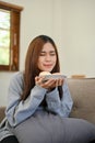 Portrait, Attractive Asian girl smelling doughnuts, tasting yummy doughnut