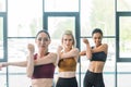 portrait of attractive multiracial sportswomen stretching before working out