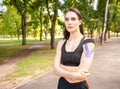 Fit woman with kinesiological taping posing outdoors. Royalty Free Stock Photo