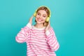 Portrait of attractive nice young girlfriend listen green headphones cheerful wear stylish shirt isolated on aquamarine