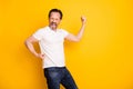 Portrait of attractive overjoyed cheerful guy dancing celebrating attainment isolated over bright yellow color