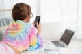 Portrait of attractive pretty woman using smartphone while lying on floor in the living room at home. Happy girl surfing internet Royalty Free Stock Photo