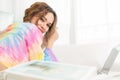 Portrait of attractive pretty woman using smartphone while lying on floor in the living room at home. Happy girl surfing internet Royalty Free Stock Photo