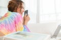 Portrait of attractive pretty woman using smartphone while lying on floor in the living room at home. Happy girl surfing internet Royalty Free Stock Photo