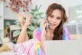 Portrait of attractive pretty woman using smartphone while lying on floor in the living room at home. Happy girl surfing internet Royalty Free Stock Photo