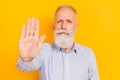 Portrait of attractive serious middle-aged man showing palm stop forbid isolated over gray pastel color background