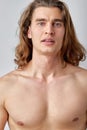 Portrait of attractive shirtless guy posing isolated over light grey color background Royalty Free Stock Photo