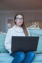 Portrait of attractive smart woman in glasses using laptop at home Royalty Free Stock Photo