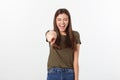 Portrait of attractive smile laugh teenage girl, pointing her finger, wear green shirt, white teeth, brown long hair