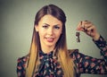 Portrait attractive smiling woman holding up set of keys belonging to her house or car Royalty Free Stock Photo