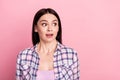 Portrait of attractive stunned girl looking aside sudden news copy space isolated over pink pastel color background