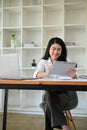 Portrait, Asian businesswoman at her office desk using digital tablet Royalty Free Stock Photo