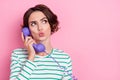 Portrait of attractive sullen worried funny girly girl talking on phone copy space news isolated over pink pastel color