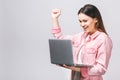 Portrait of attractive surprised excited smiling business woman hold hand up looking at laptop screen, isolated over white Royalty Free Stock Photo