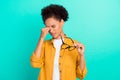 Portrait of attractive tired girl holding specs touching nose suffering isolated over vibrant teal turquoise color Royalty Free Stock Photo