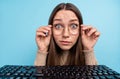 Portrait of attractive trendy amazed funny girl reading making web video call isolated over bright blue color background Royalty Free Stock Photo