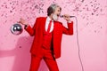 Portrait of attractive trendy cool talented grey-haired man singing hit night club isolated over pink pastel color