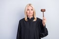 Portrait of attractive trendy experienced middle-aged woman judge holding gavel isolated over grey pastel color