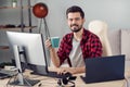 Portrait of attractive trendy skilled cheery guy drinking beverage writing code start-up project report at office work Royalty Free Stock Photo
