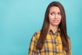 Portrait of attractive unsatisfied young lady look empty space grin teeth isolated on blue color background