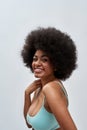 Portrait of attractive voluptuous young female model with afro hair style wearing blue underwear smiling at camera